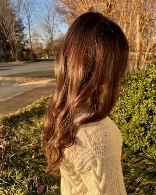 Long brunette hair with soft, sun-kissed dimension, finished at LuLu Salon