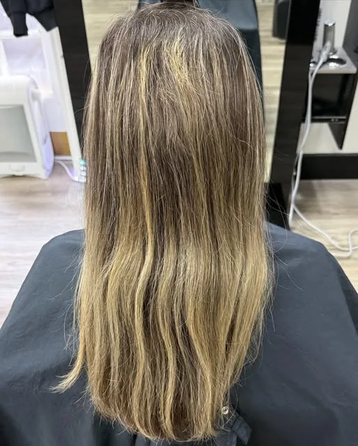 Long dimensional blonde highlights on straight hair at LuLu Salon