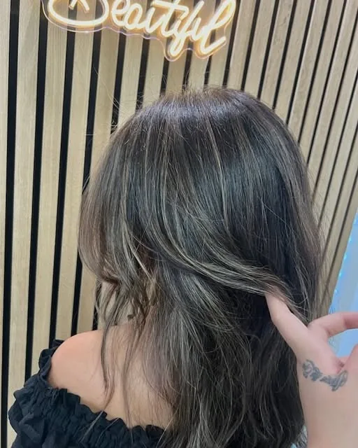 Dark hair with bright face-framing highlights