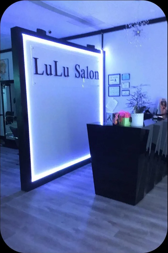 LuLu Salon front desk lit in the evening
